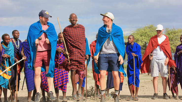 Tourists engaging with a Maasai community during a cultural visit