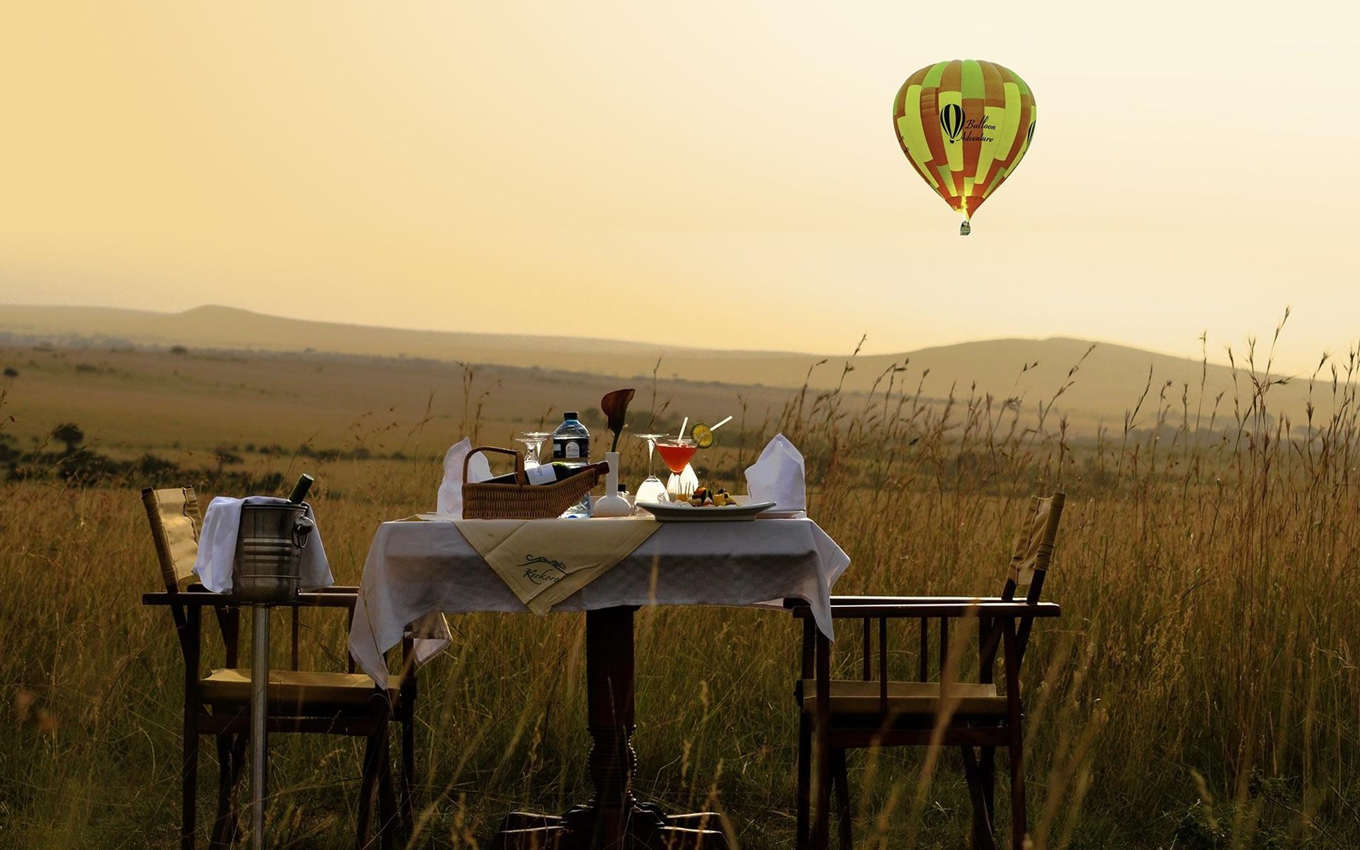 Luxury Safari Planning: What Client Feedback Teaches Us About Better Safari Experiences 9 A bush picnic set up in the Mara, with a hot air balloon overhead